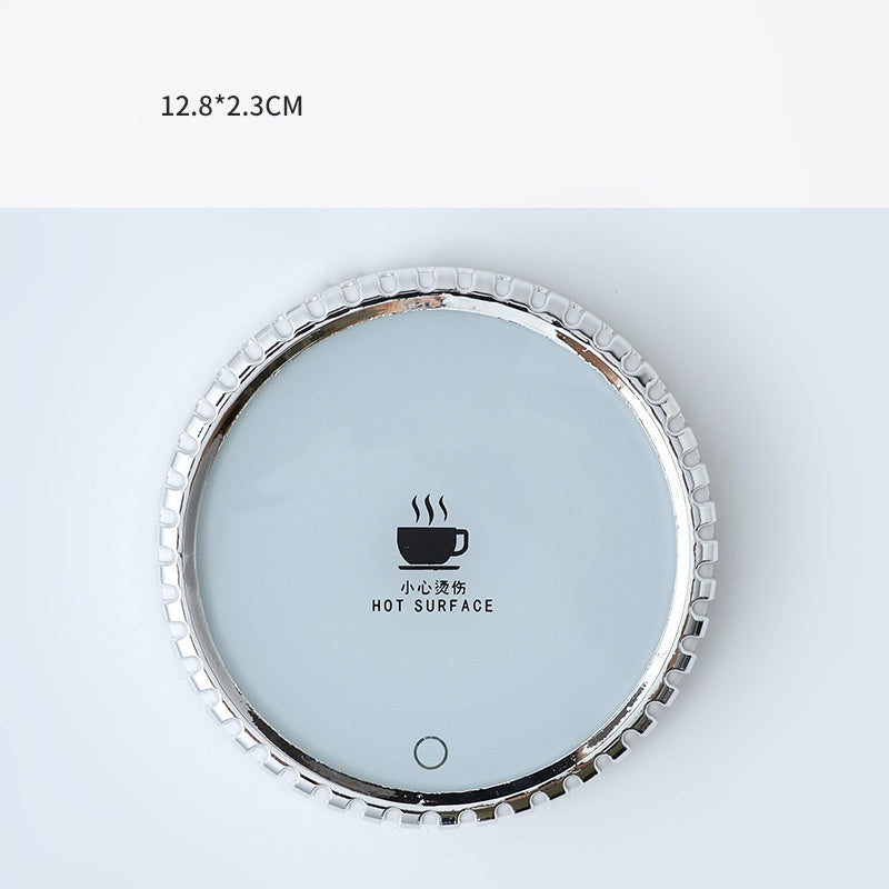 Mug on a round heated coaster with metallic rim