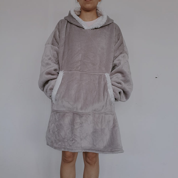 Person wearing an oversized blanket hoodie