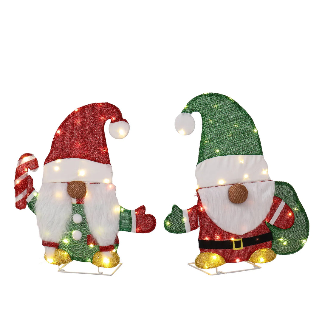 Two lighted Christmas gnomes in a yard