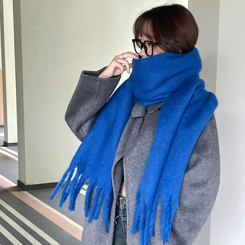 Woman wrapped in a fluffy oversized scarf