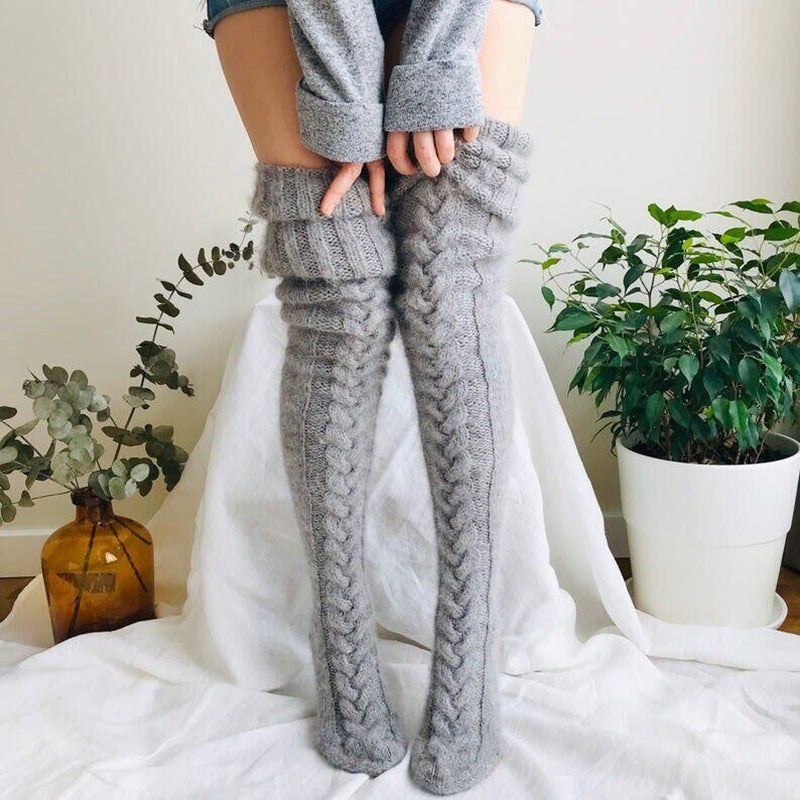 Woman wearing over-the-knee cable knit socks