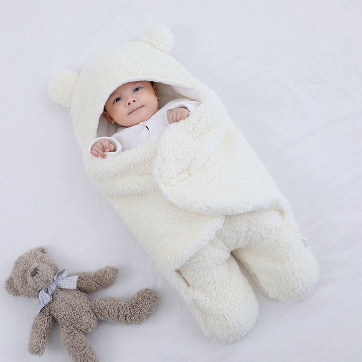 Baby in a plush bear-ear hooded wrap