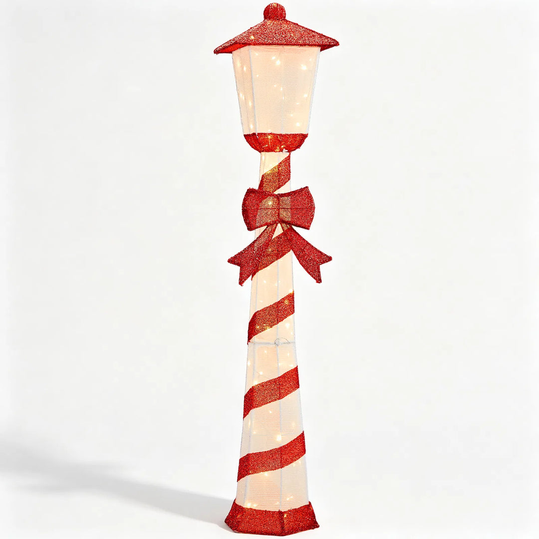 Lighted candy cane striped Christmas lamp post on a porch