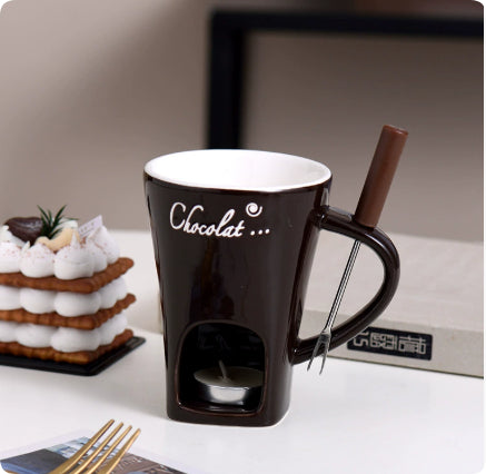 Ceramic fondue mug with fork and tealight