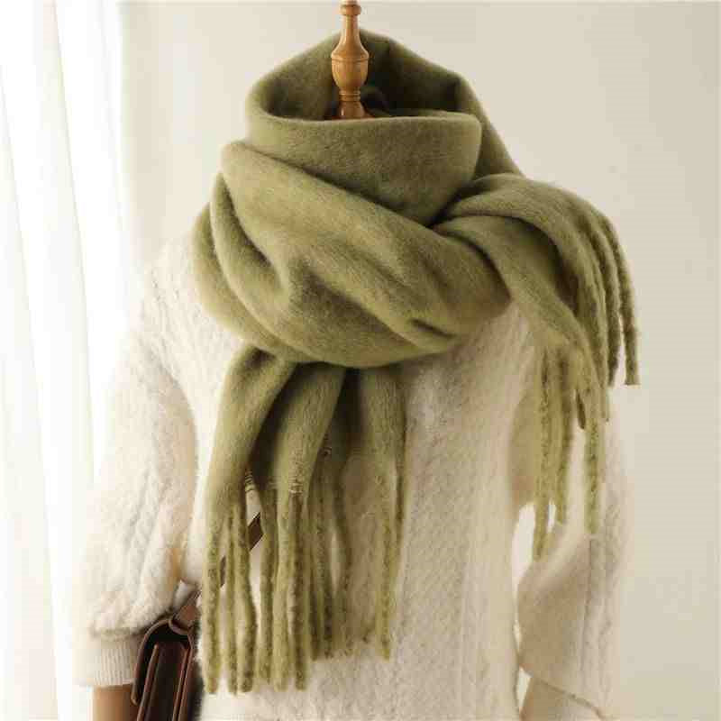 Woman wearing a fluffy mustard scarf
