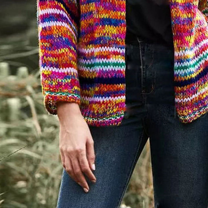 Woman in a rainbow striped chunky cardigan