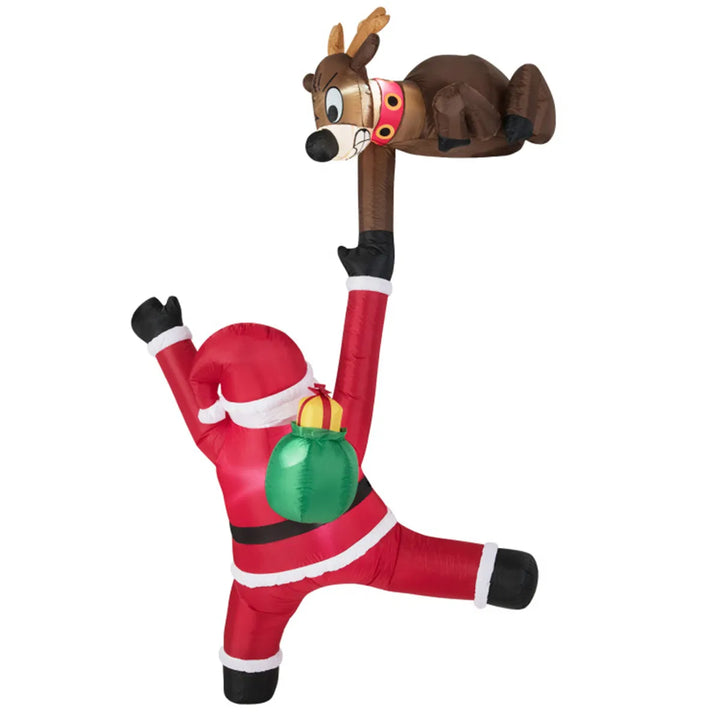 Inflatable climbing Santa and reindeer glowing outdoors