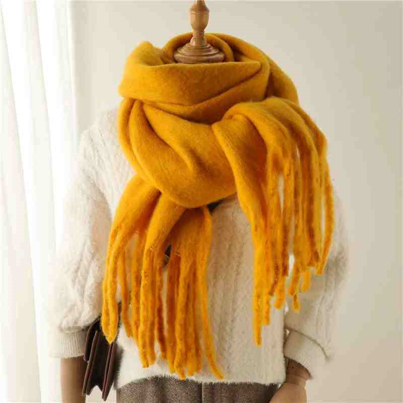 Woman wearing a fluffy mustard scarf