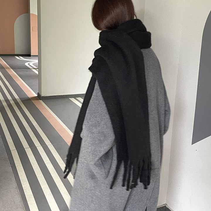 Woman wrapped in a fluffy oversized scarf