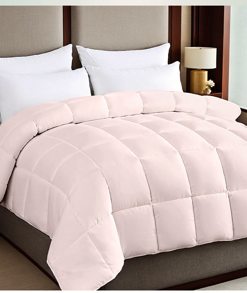 Pink box stitched comforter on a bed