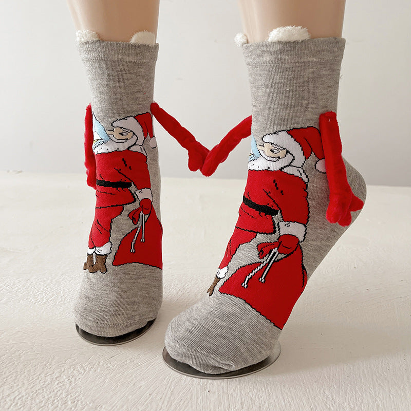 Couple wearing magnetic Christmas socks