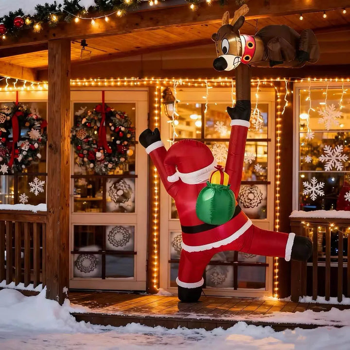 Inflatable climbing Santa and reindeer glowing outdoors