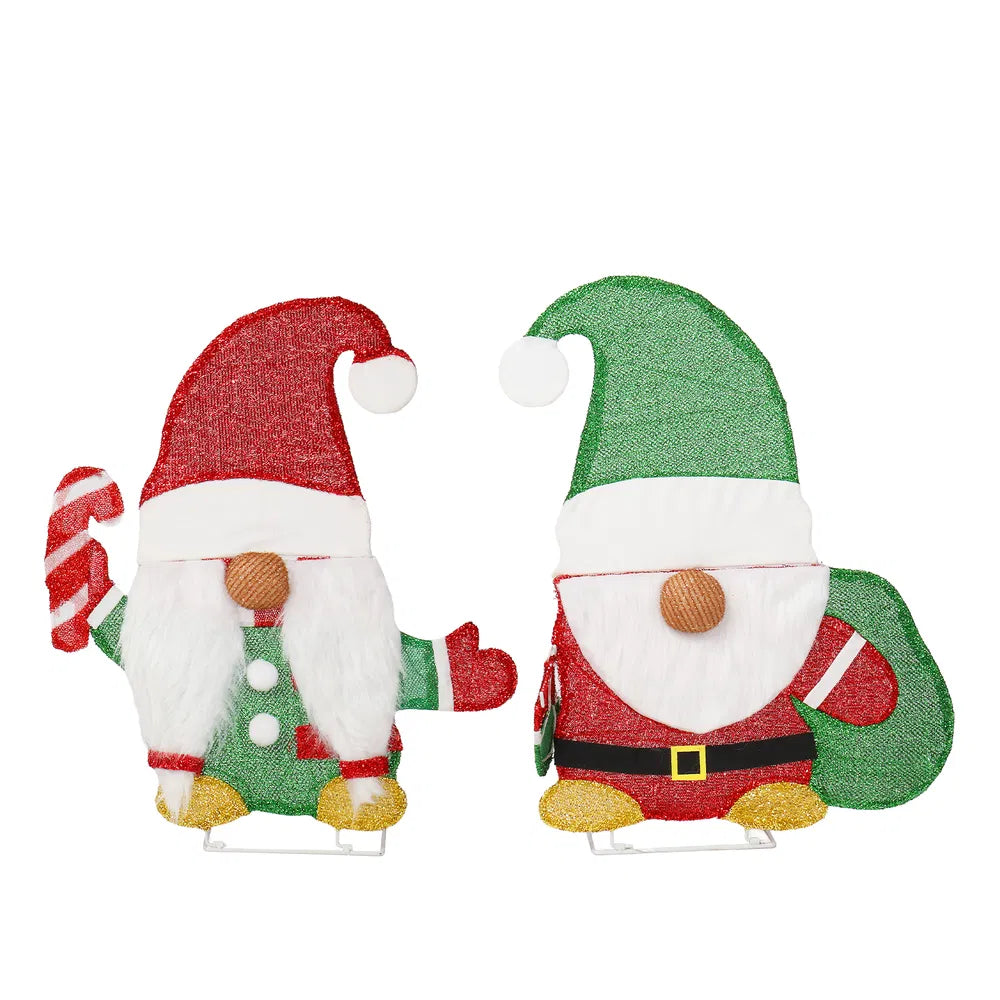 Two lighted Christmas gnomes in a yard