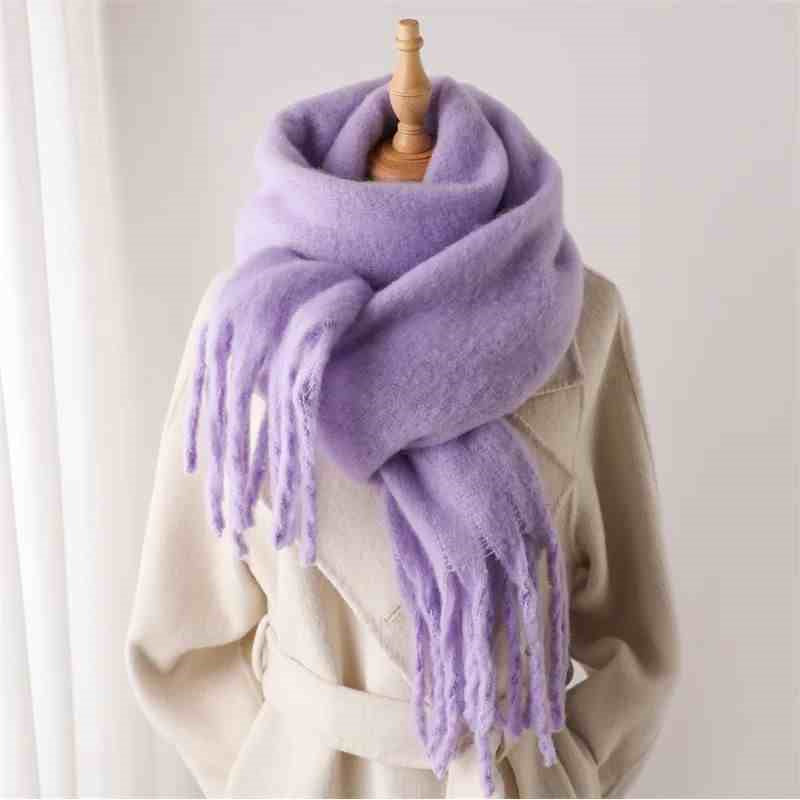 Woman wearing a fluffy mustard scarf