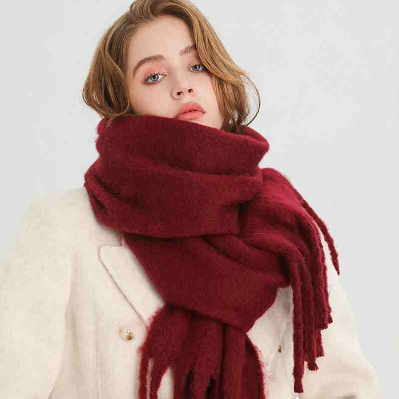 Woman wearing a fluffy mustard scarf
