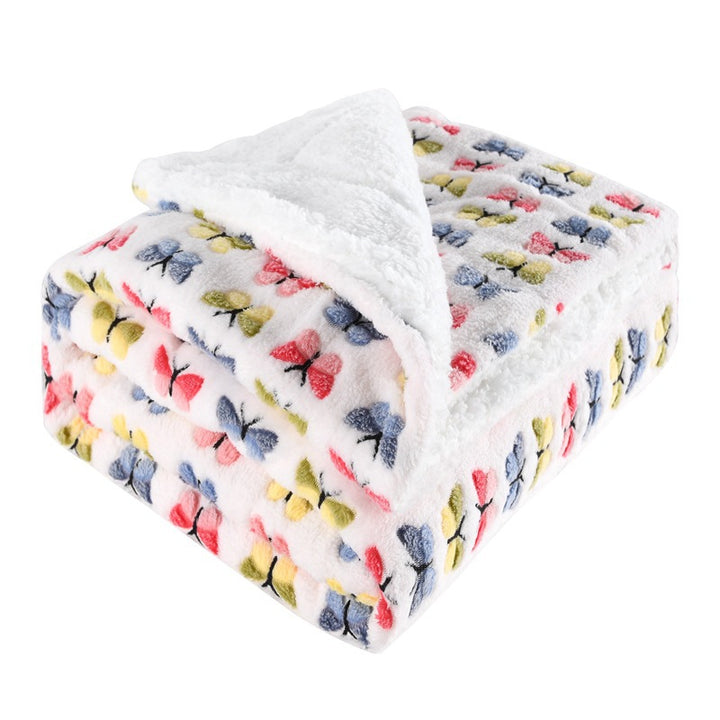Thick sherpa fleece throw on a sofa