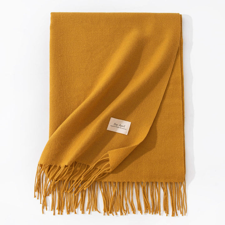 Woman wearing a wide caramel scarf shawl
