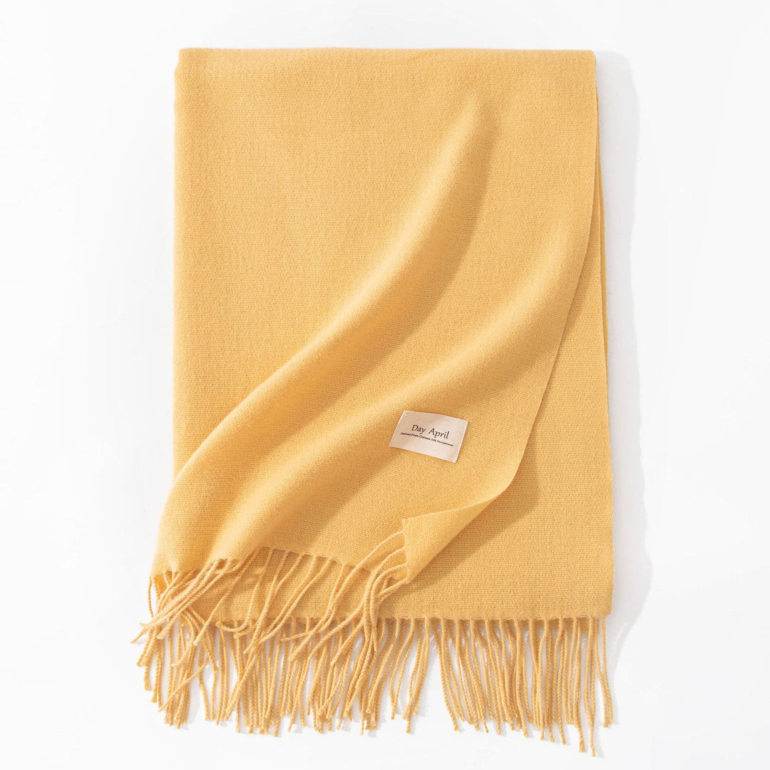 Woman wearing a wide caramel scarf shawl