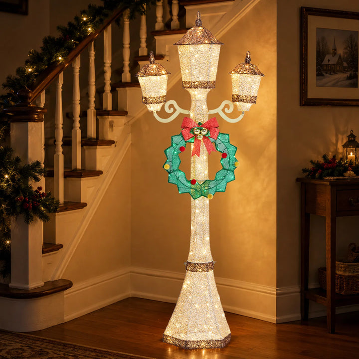 Gold Christmas lamp post with wreath glowing