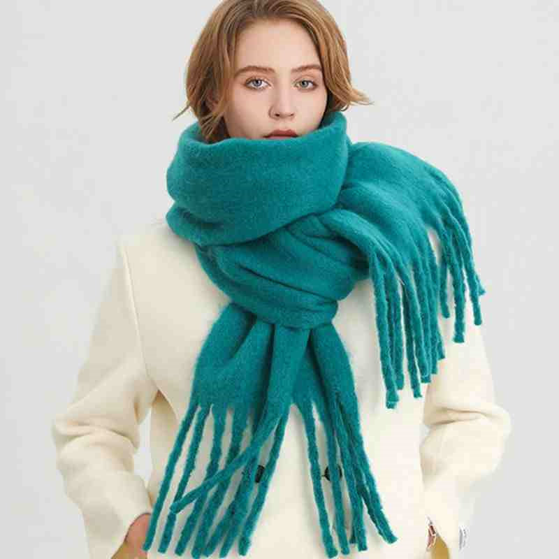 Woman wearing a fluffy mustard scarf