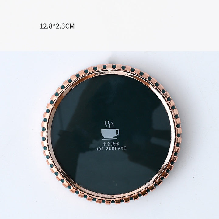 Mug on a round heated coaster with metallic rim