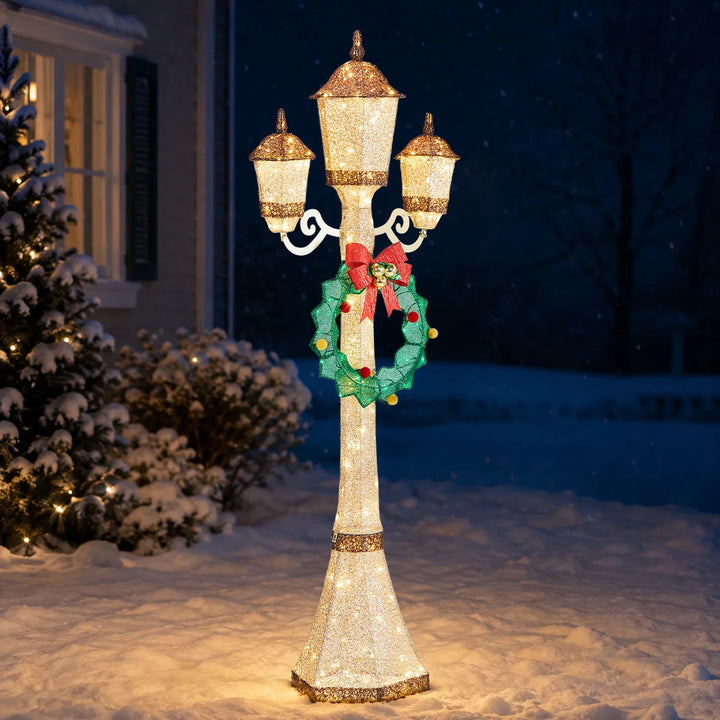Gold Christmas lamp post with wreath glowing